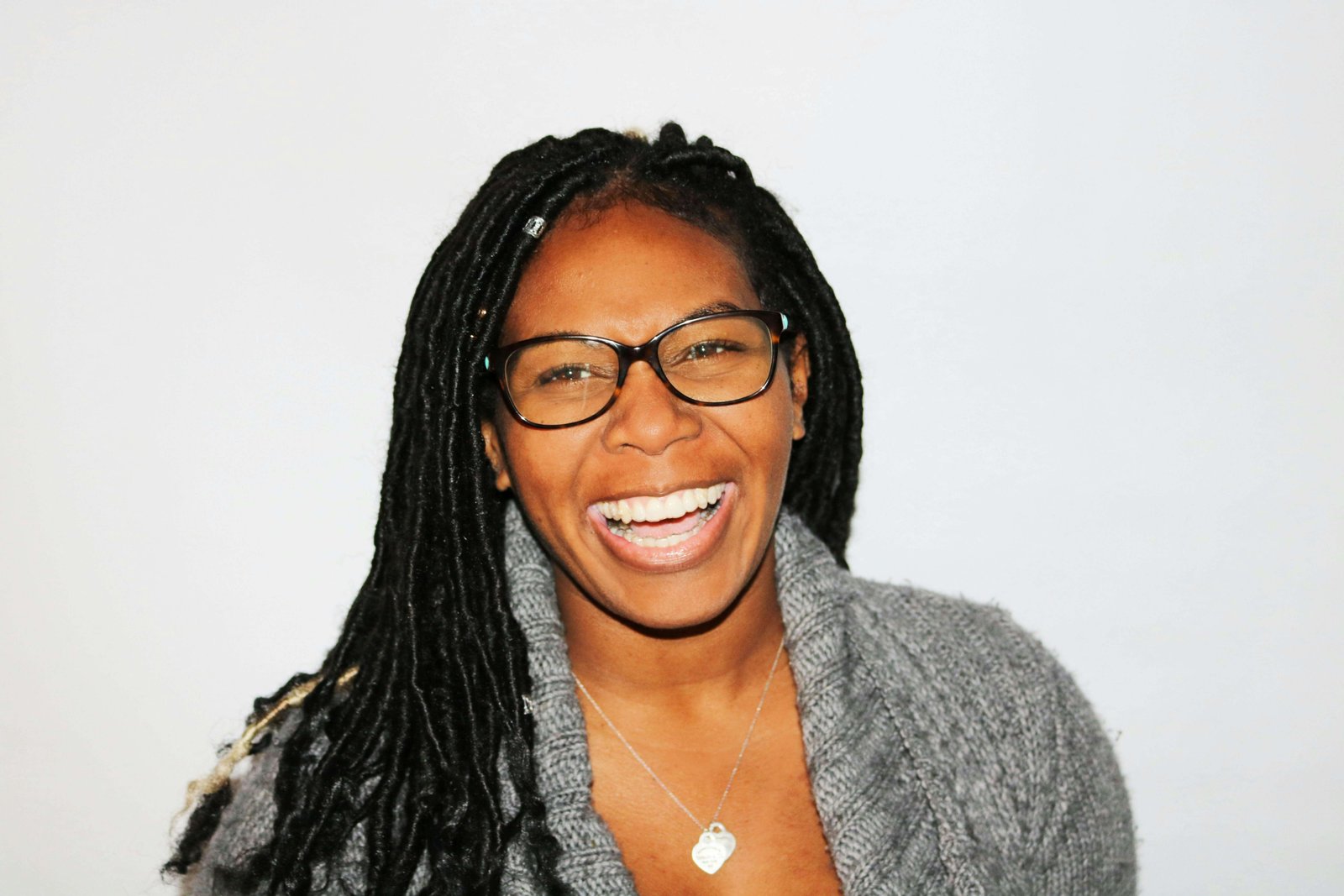 smiling woman wearing white and black pinstriped collared top
